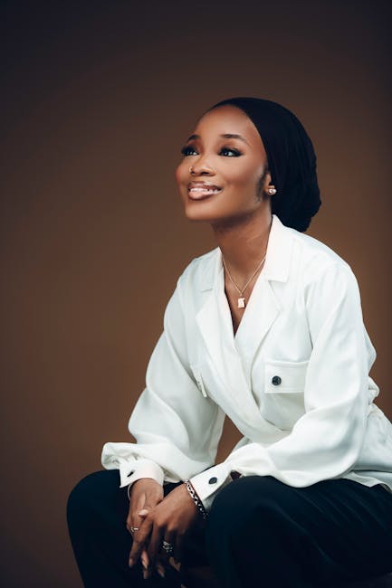 Elegant portrait of a smiling woman in business attire, exuding confidence and style.