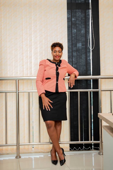 Portrait of a confident businesswoman standing indoors in a modern office.